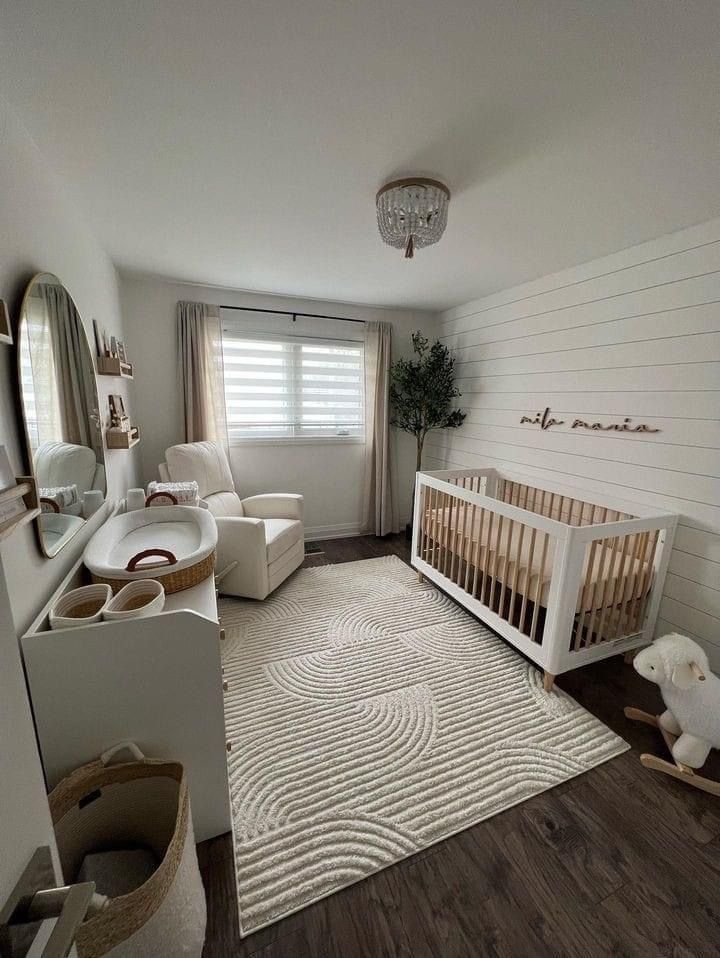 a baby's room with white walls and wood floors is pictured in this image