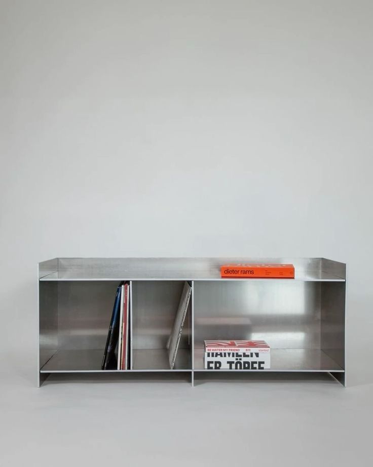 a metal shelf with books and magazines on it