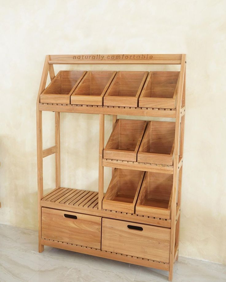 a wooden shelf with drawers and baskets on it