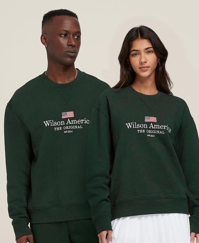 The cozy sweatshirt to grab for warm-ups, chilly gym commutes or long recovery days. Dense and impossibly soft, the Wilson America Crewneck comes in heavyweight cotton that feels lived-in from the start. It's made in the USA with all the marks of a classic, from the V-stitch collar to the easy, co-ed fit. | Wilson Wilson America Crewneck - Size XS Wilson Sporting Goods, Ed Design, V Stitch, Green Sweatshirt, Xl Girls, Cozy Sweatshirts, The Start, Breathable Fabric, Fun Sports