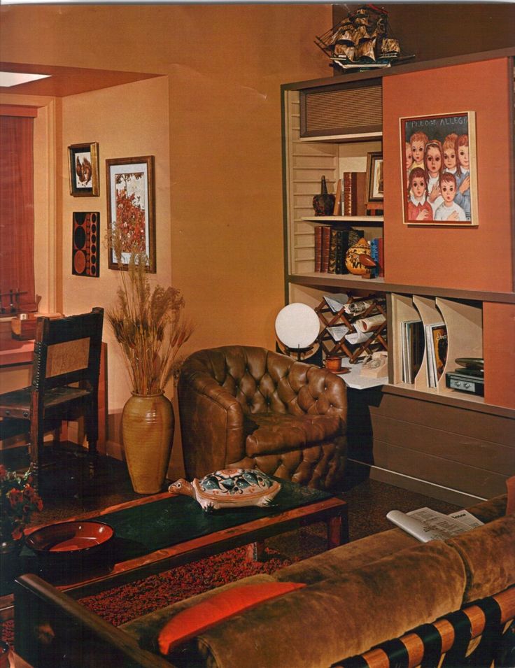 a living room filled with furniture and pictures on the wall