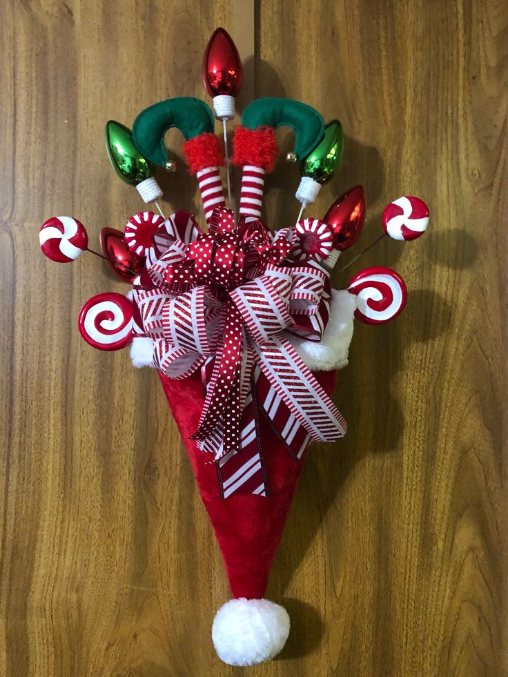 a candy cane christmas decoration hanging on a wall