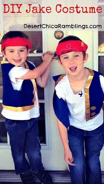 two young boys wearing pirate costumes standing next to each other