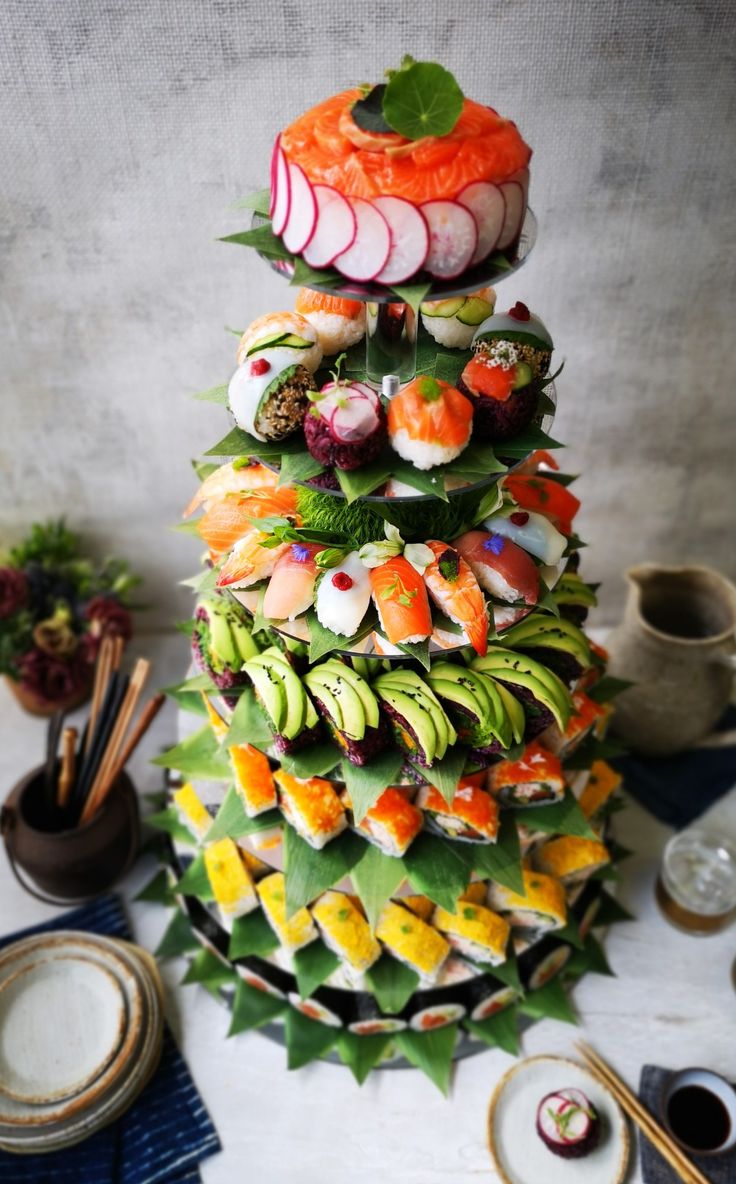 there is a very colorful sushi tower on the table