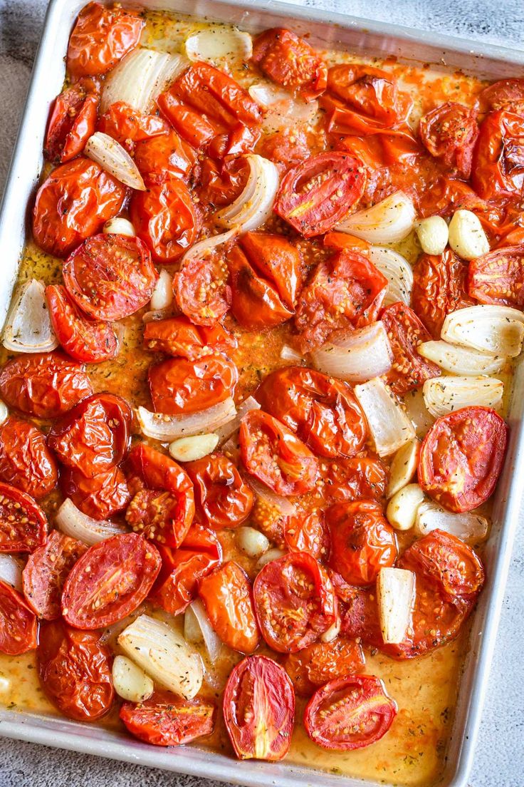 tomatoes and onions are in a baking dish