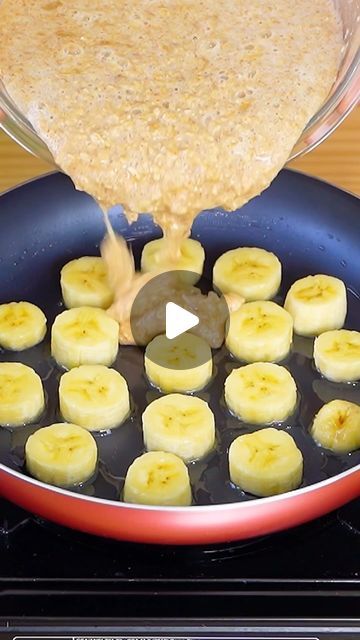 bananas being cooked in a skillet on top of the stove with sauce pouring over them