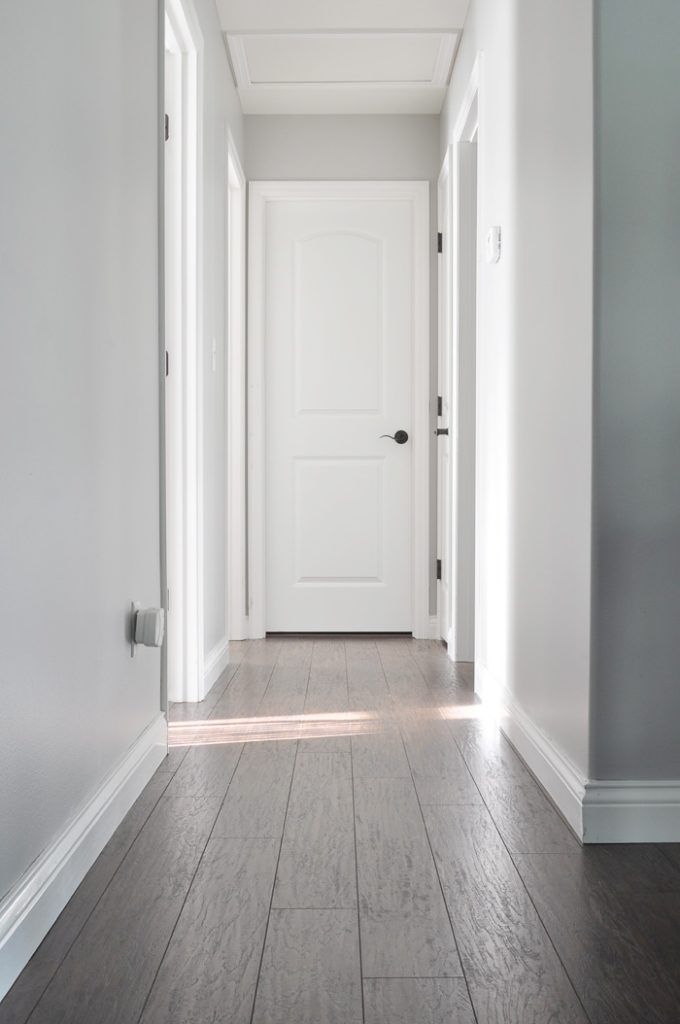 an empty hallway with white walls and wood floors is featured in the instagram page