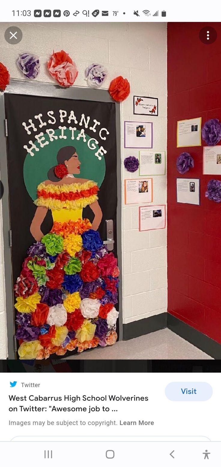 an image of a classroom door decorated with flowers and tissue paper pom poms