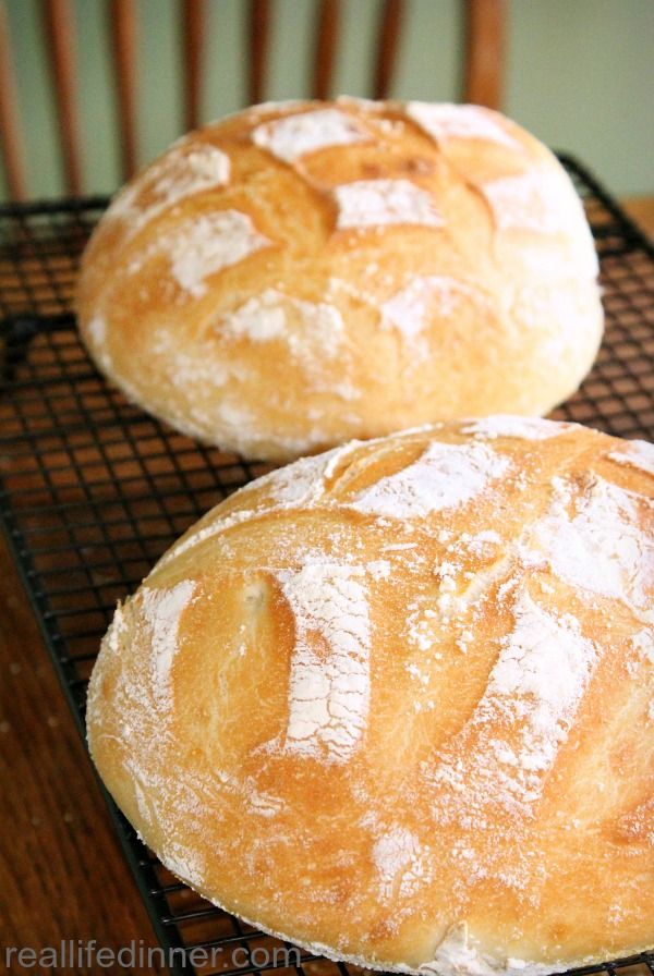 two loaves of bread sitting on top of a cooling rack