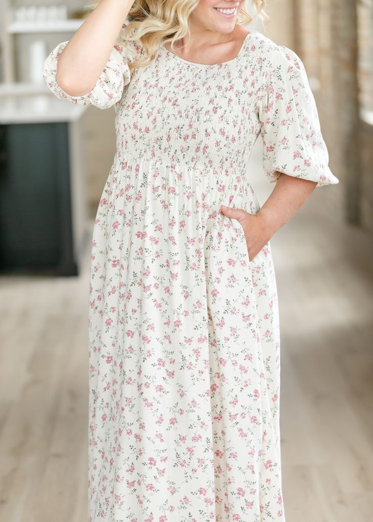 The Kayleen Smocked Bodice Maxi Dress is an Inherit Design is inspired by femininity and honor that is our Biblical calling. It features a modest square neckline and smocked bodice perfect for nursing mama's and all day comfort! Made from breathable material in a maxi length, with side pockets to hold ALL the things! Wear the Kayleen to the next wedding on your calendar, to church, or for family photos! Style | Maxi Dresses Color | Pink SIZING TIPS Fit | Semi-Fitted Stretch | Mid-Stretch Model | Modest Fitted Smocked Dress, Fitted Modest Smocked Dress, Feminine Smocked Dress With Square Neck And Gathered Sleeves, Feminine Smocked Dress With Gathered Sleeves And Square Neck, Modest Smocked Dress For Garden Party, Modest Fitted Smocked Dress For Garden Party, Daywear Smocked Dress With Square Neck, Smocked Bodice Dress With Square Neck For Daywear, Modest Smocked Dress With Puff Sleeves