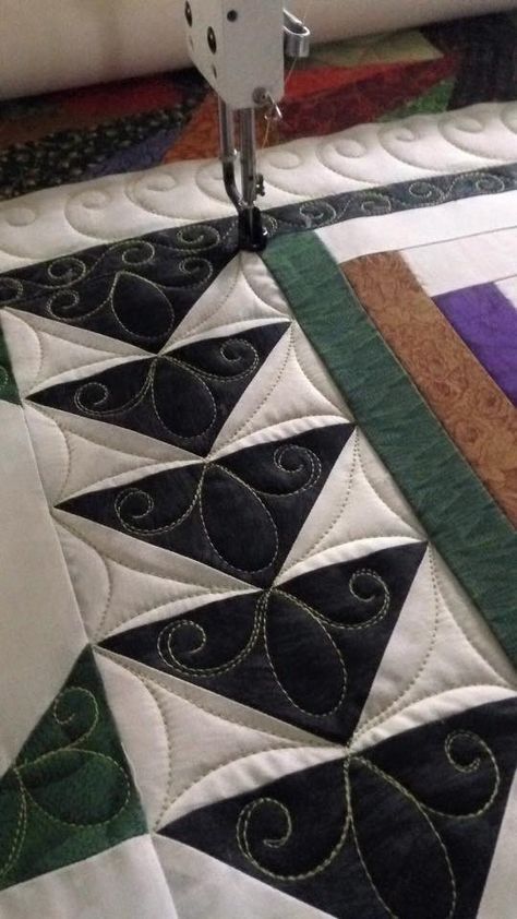 a close up of a quilting machine on a table with a piece of fabric