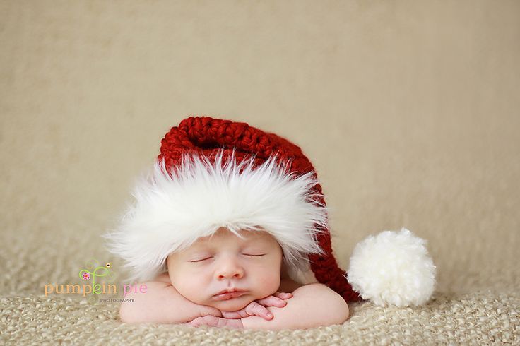 a newborn baby wearing a santa hat