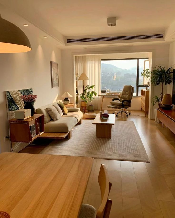 a living room filled with furniture and a flat screen tv sitting on top of a wooden table