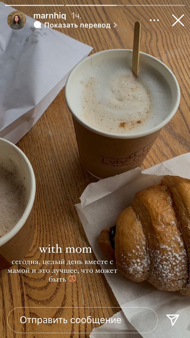 two cups of coffee and some pastries on a table with information about the drink