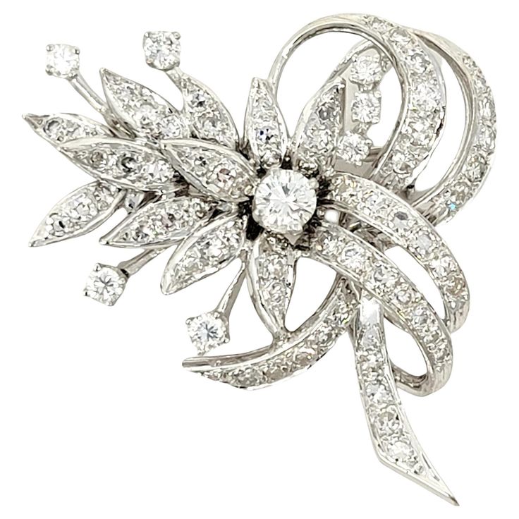 Gorgeous vintage style brooch bursting with incredible sparkle. This absolutely beautiful brooch is made of 14 karat white gold and arranged in a horizontal layout. It features 73 icy white natural round brilliant diamonds set in a clustered floral motif with swirling ribbon-like accents. The gentle curve of the piece adds a feminine touch and makes the glittering stones really pop. The diamonds are all set in polished white gold, truly enhancing their white brilliance. Also features a single hi Luxury White Hallmarked Brooches, Luxury White Round Brooch, Luxury White Flower Brooches, White Brilliant Cut Brooches For Wedding, White Brilliant Cut Wedding Brooches, Classic White Diamond Brooches, Luxury White Diamond Brooch, Vintage White Gold Brooches With Brilliant Cut, Floral Ribbon