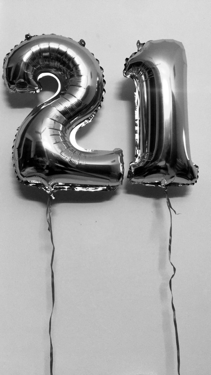 the number twenty two balloons are hanging on the wall