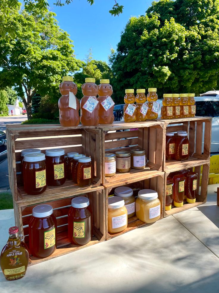 several wooden crates filled with different types of honey