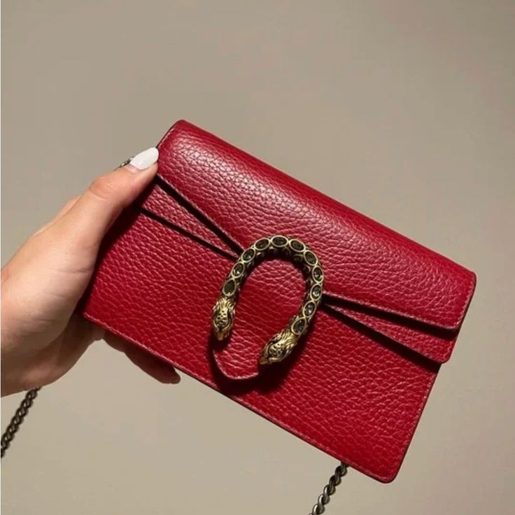 Gucci Crossbody Bag Red Leather Dionysus Accent Multitonal Hardware Chain-Link Shoulder Strap Single Exterior Pocket Suede Lining & Single Interior Pocket Push-Lock Closure At Front Includes Box & Dust Bag Shoulder Strap Drop: 23.75" Height: 4.5" Width: 6.75" Depth: 1.5" Chic Gucci Rectangular Bag, Gucci Bags With Detachable Strap, Gucci Clutch Shoulder Bag With Gold-tone Hardware, Gucci Pouch Bag With Detachable Strap, Gucci Evening Bags With Top Handle, Gucci Evening Shoulder Bag, Luxury Handheld Bag With Chain Strap, Gucci Handheld Shoulder Bag, Gucci Evening Crossbody Shoulder Bag