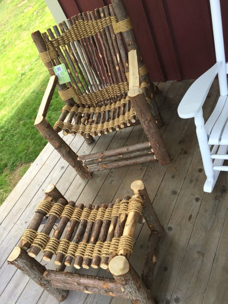 two chairs made out of logs sitting on a porch