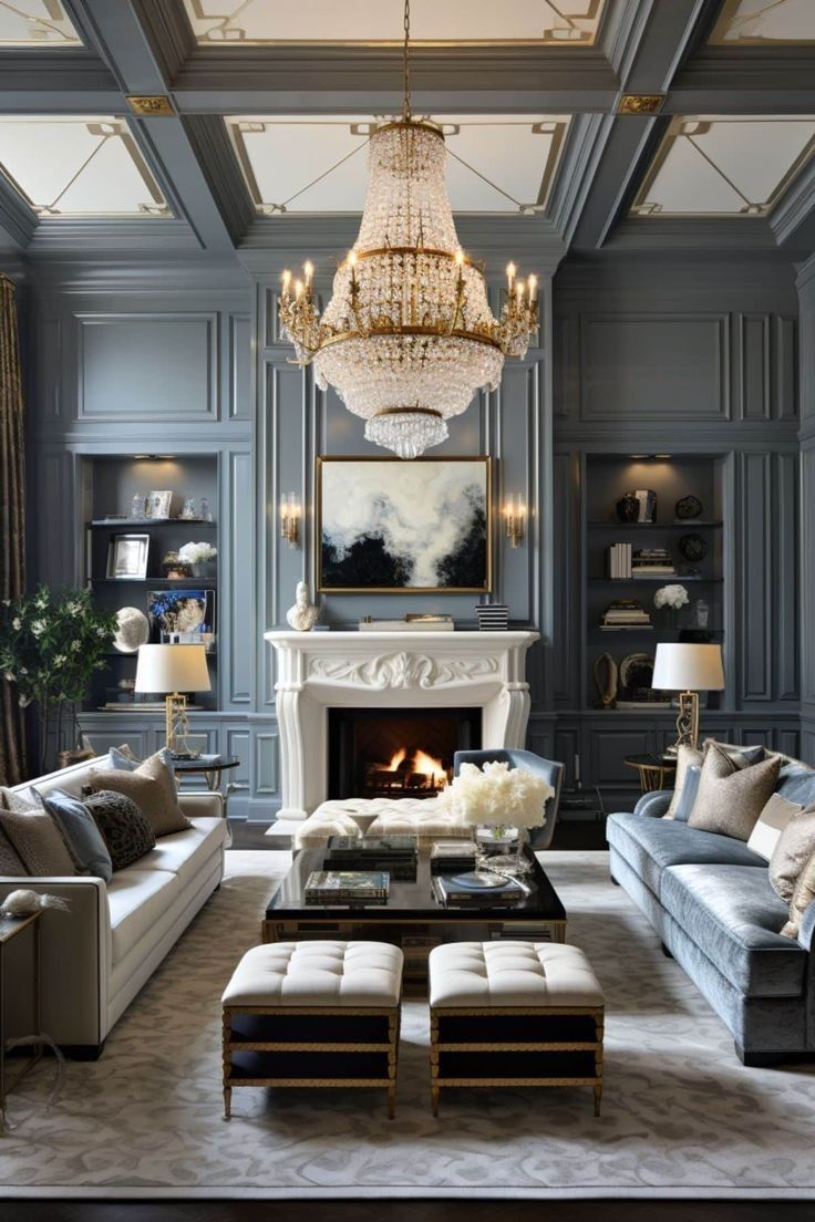 a living room filled with furniture and a chandelier above a fire place in front of a fireplace