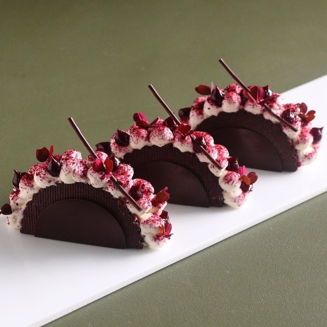 three pieces of chocolate with white and red toppings