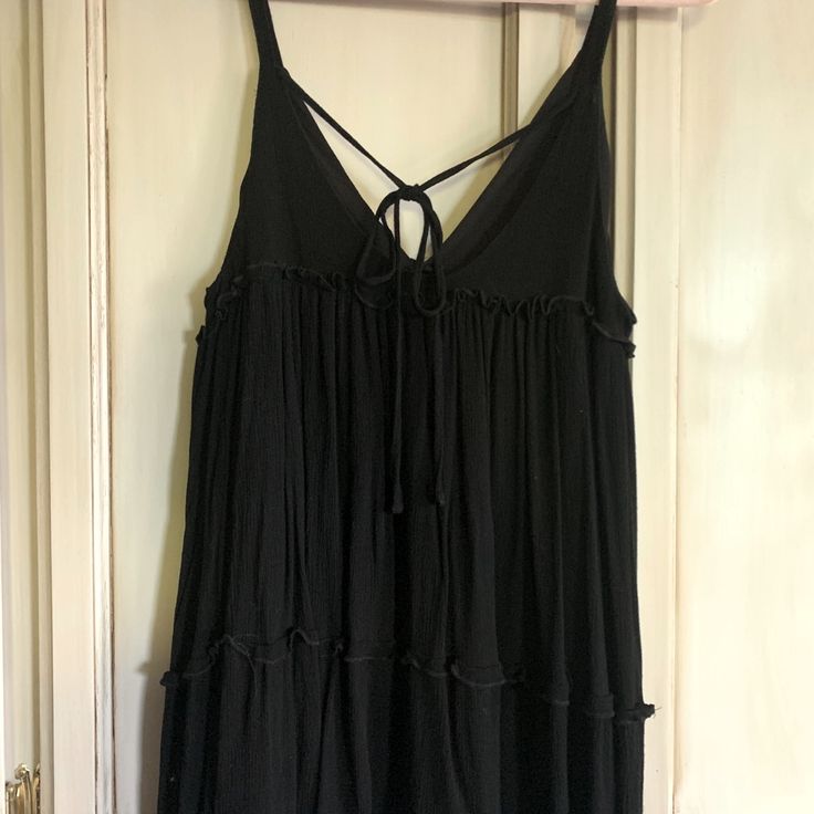 Brand New Never Worn Sexy Black Summer Dress, Spaghetti Straps, Ties In Back. Black Mini Dress With Straps For Vacation, Black Flirty Tank Top For Summer, Flirty Black Tank Top For Summer, Flirty Black Summer Tank Top, Black Camisole Mini Dress For Beach, Black Camisole Mini Dress For The Beach, Black Strap Beach Dress, Black Mini Dress With Adjustable Straps For Vacation, Black Camisole With Straps For Summer