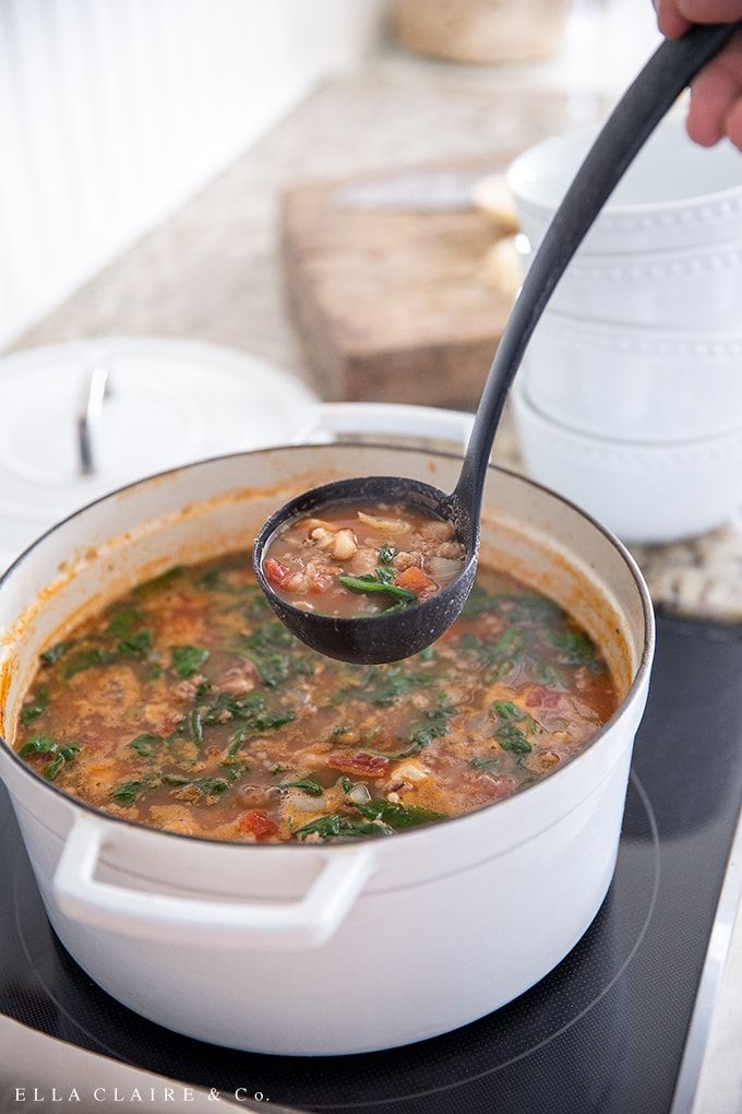 a person is stirring a pot of soup on the stove