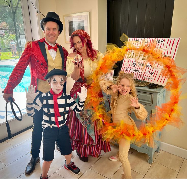 three people in costumes posing for a photo with a child and an adult standing behind them