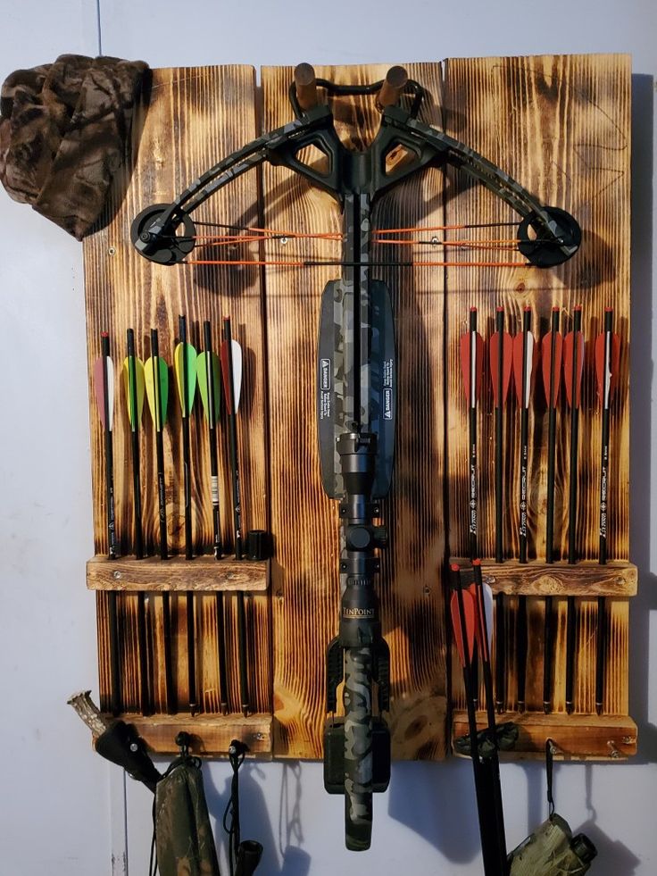 a wall mounted archery target rack with arrows