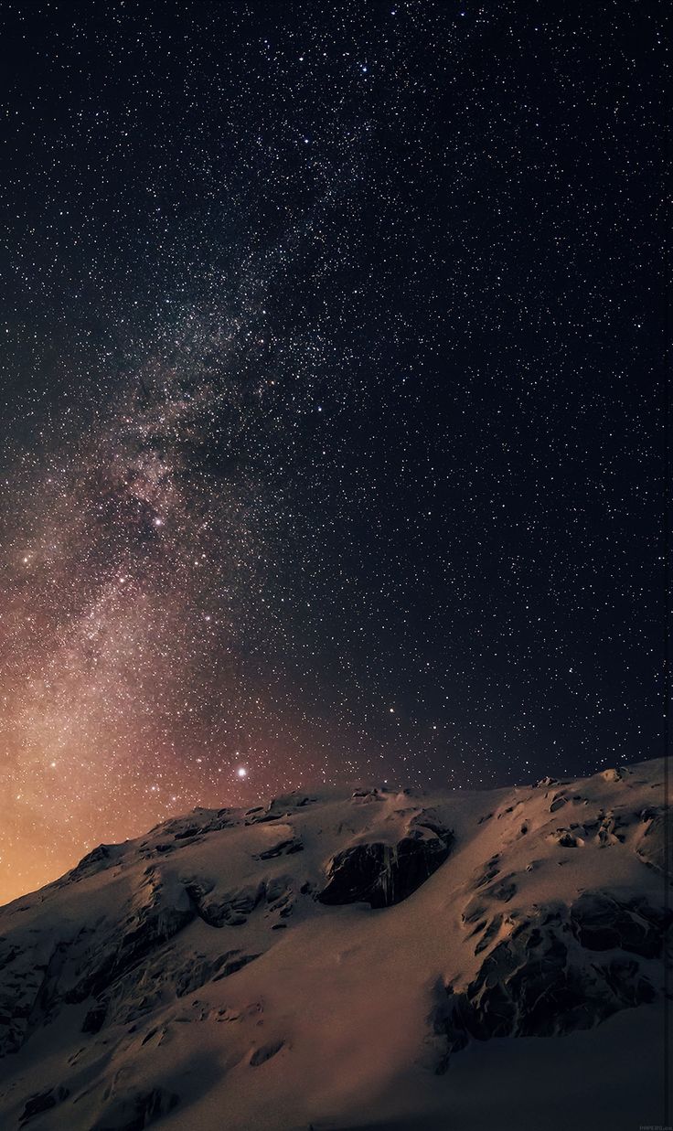 the night sky is filled with stars above a snowy mountain