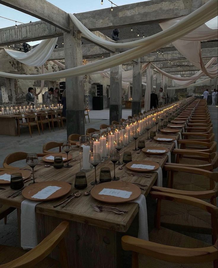 an image of a table setting with candles and place settings on the table for dinner