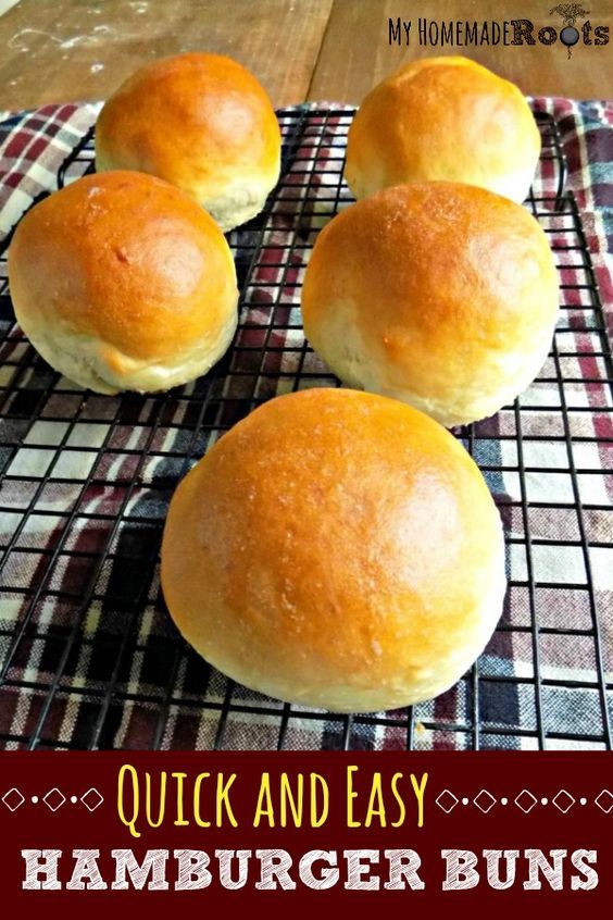 four bread rolls sitting on top of a cooling rack