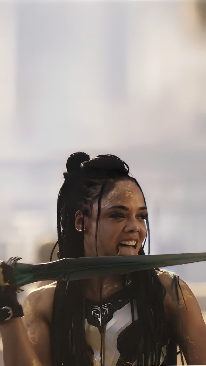 a woman with dreadlocks holding a baseball bat