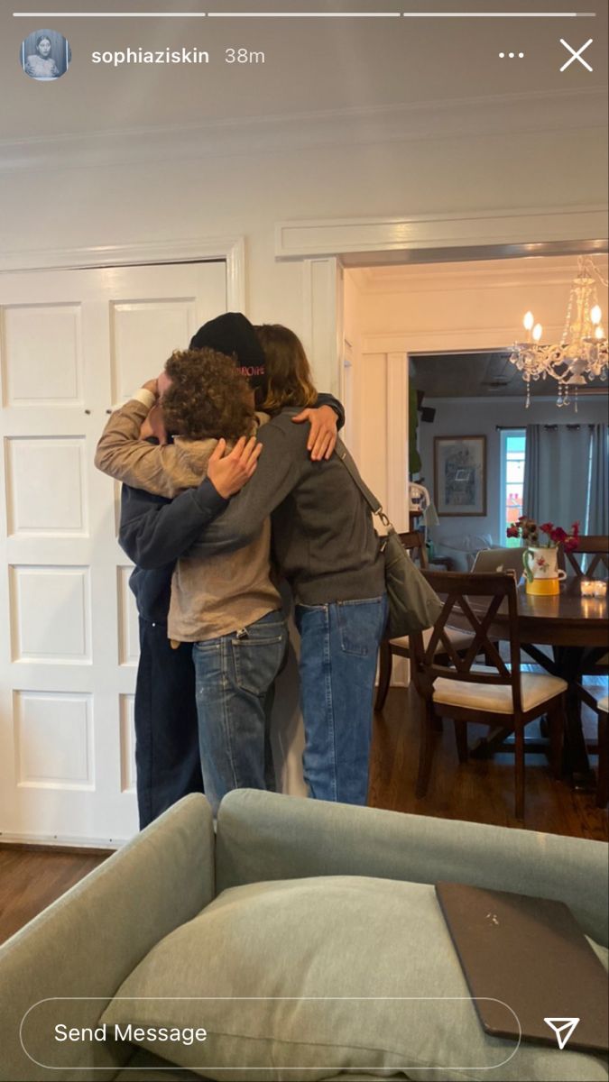 two people hugging each other in the living room