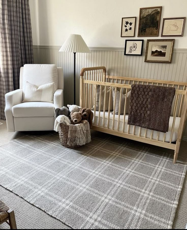 a baby crib in the middle of a room with pictures on the wall and an infant's bed next to it