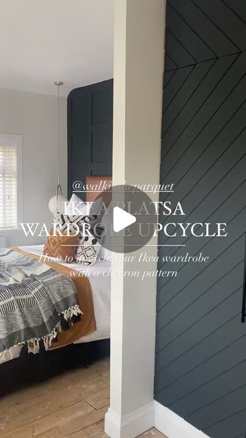 a bedroom with wood floors and gray walls