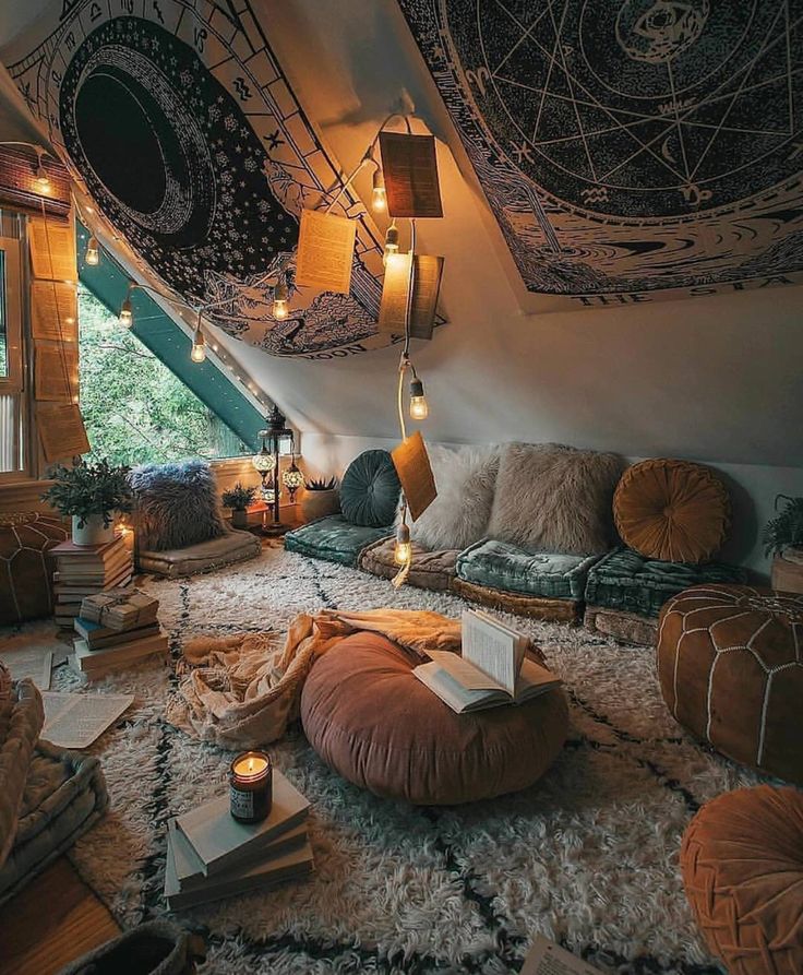 a room with lots of pillows and lights on the ceiling