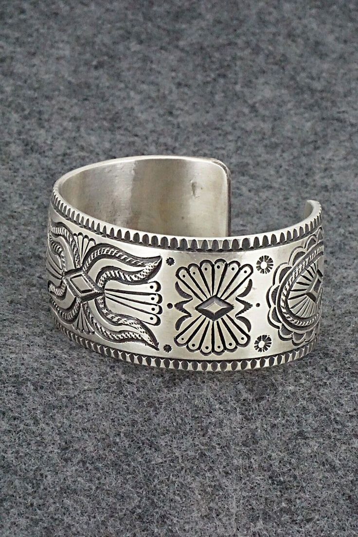 This exceptionally crafted sterling silver bracelet was made by Navajo silversmith Calvin Martinez. The inside is signed C MTZ, Navajo and stamped sterling.Size: 5 3/8" (will fit up to a 6 3/8" wrist)Gap: 1"Width: 1 1/16"Free shipping on all orders! We ship with USPS and always include tracking. All orders ship within a day of payment.Returns are accepted up to 30 days after you receive your order. Just send us a message. Our shop offers cash back or store credit. The item must be returned in ne Bohemian Antique Silver Sterling Silver Bracelet, Handcrafted Silver Bracelets As Gift, Hand Tooled Silver Bracelet As A Gift, Hand Tooled Silver Bracelets As A Gift, Silver Hand Tooled Bracelet For Gift, Bohemian Antique Sterling Silver Bracelet, Hand Tooled Silver Bracelet For Gift, Bohemian Etched Sterling Silver Bracelets, Bohemian Sterling Silver Engraved Bracelet