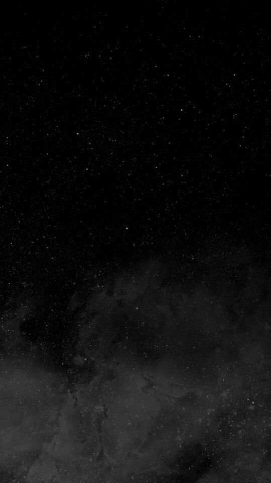 a black and white photo of some clouds in the night sky with stars on it