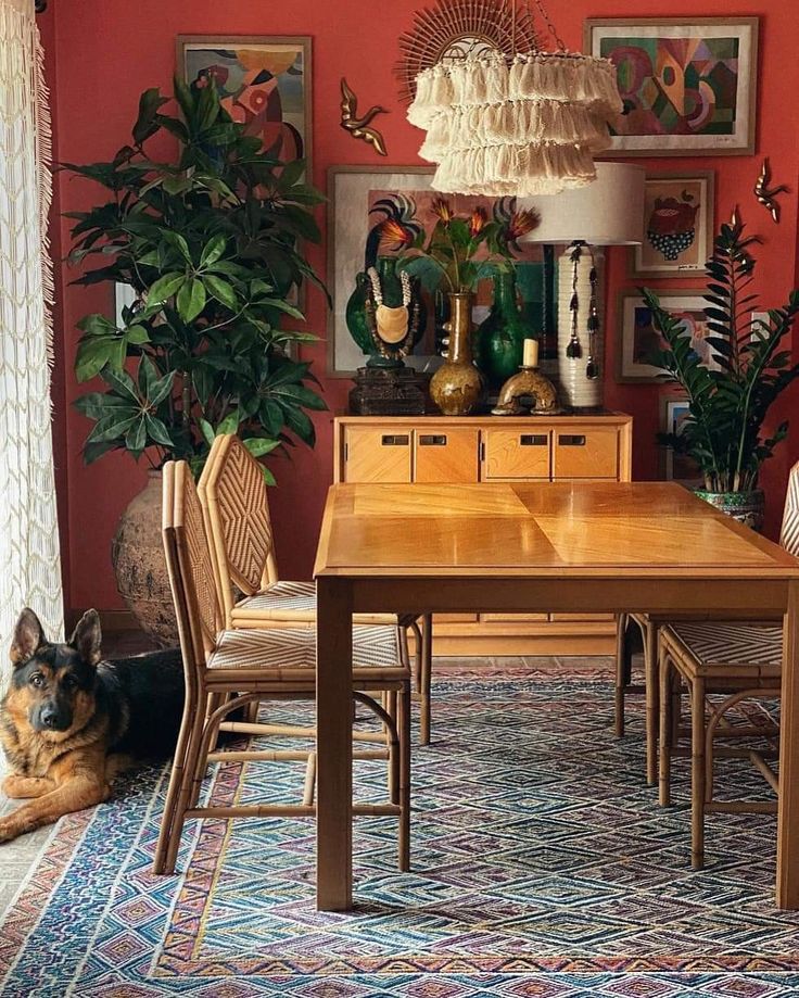 a dog laying on the floor in front of a dining room table with chairs and rug