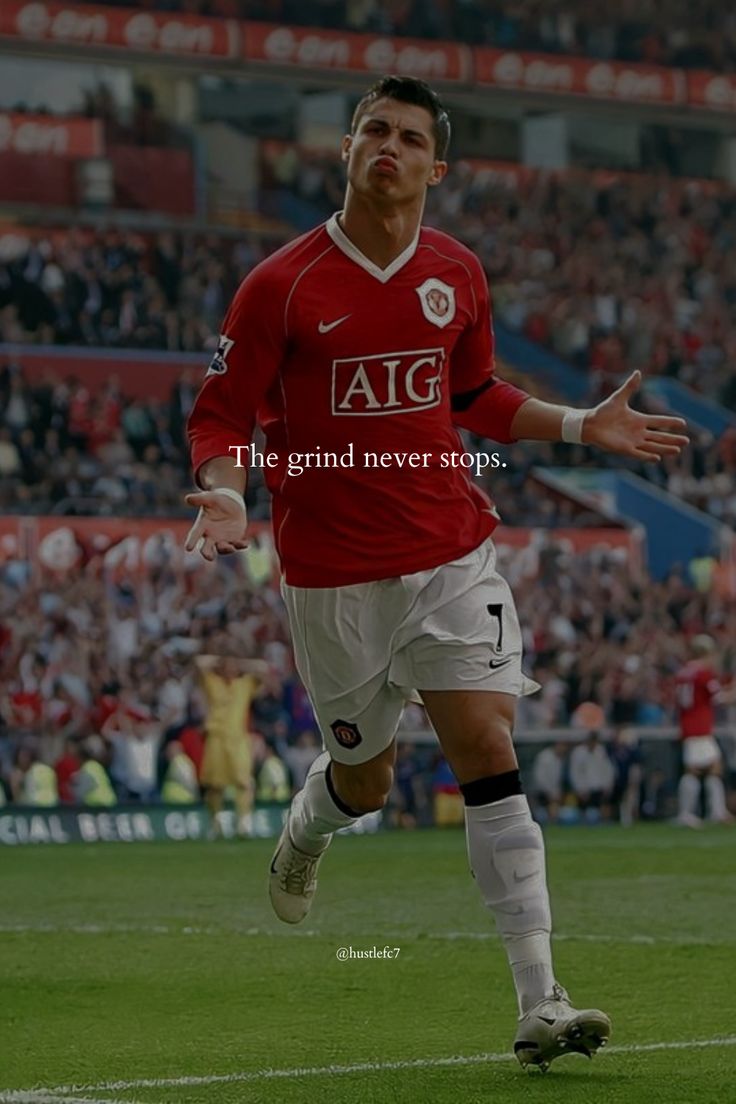 a soccer player is running on the field with his arms out and feet in the air