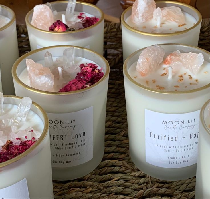 several candles with different types of crystals in them