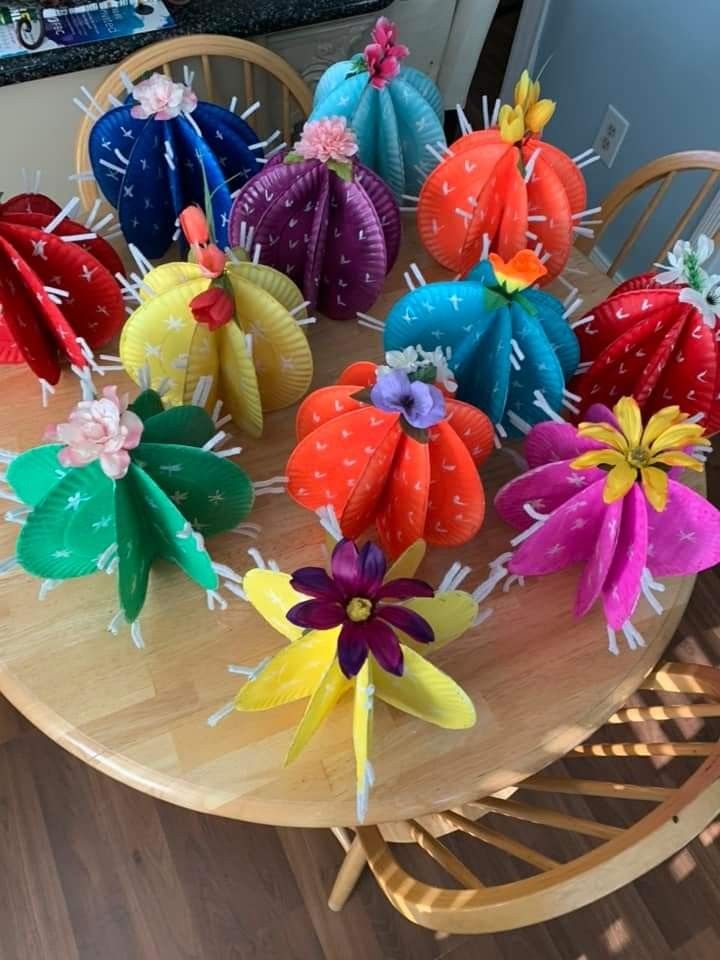 many colorful paper flowers on a wooden table