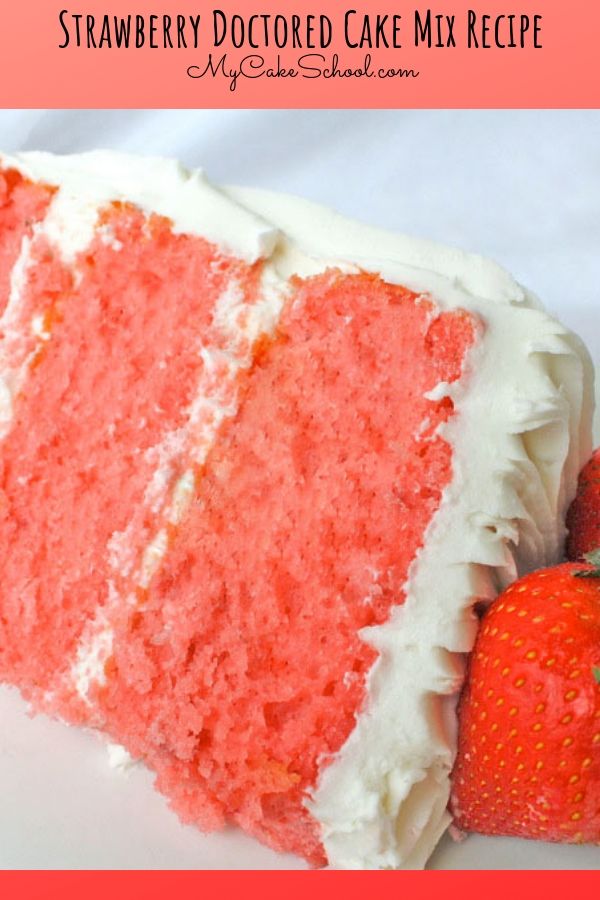 a slice of red velvet cake with white frosting and strawberries on the side