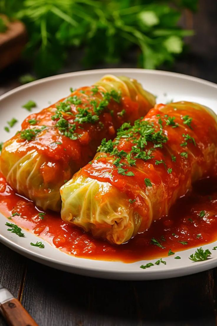 cabbage stuffed with sauce and parsley on a white plate