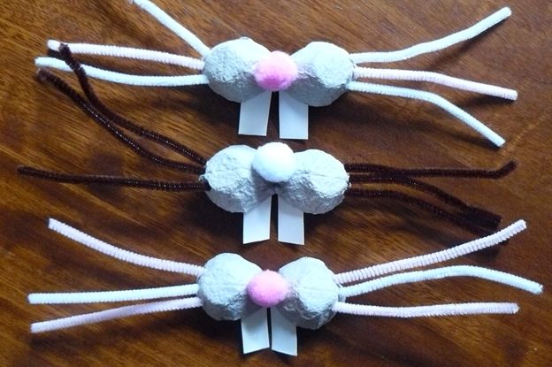 three bunny ears made out of marshmallows on top of a wooden table