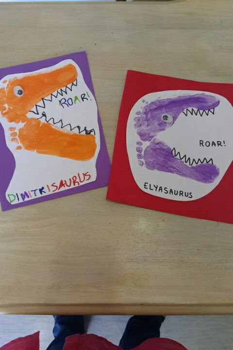 two children's handprints are displayed on the table next to each other