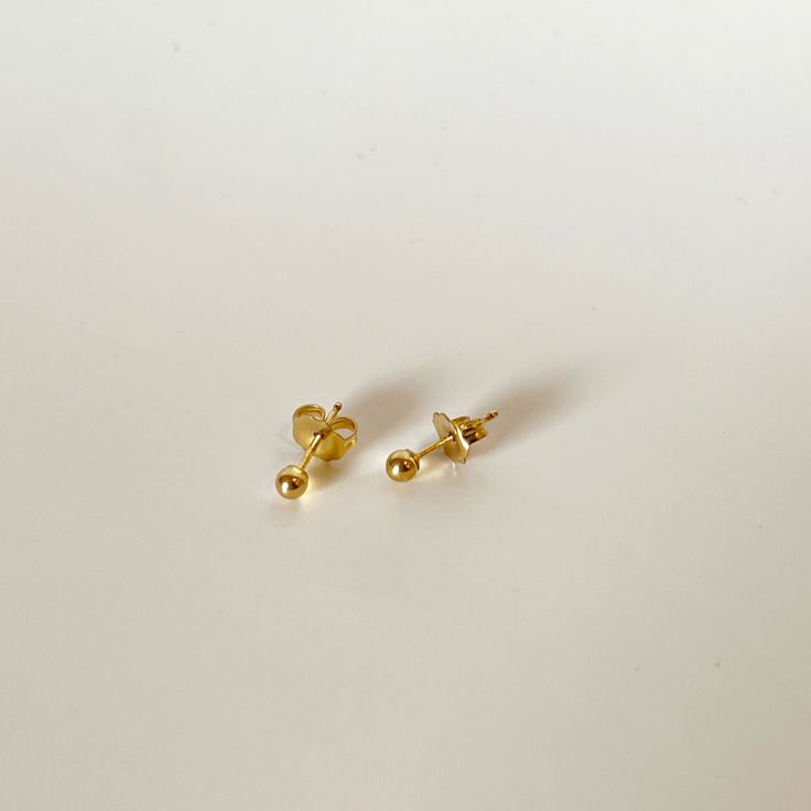 The Gold Dot Stud Earrings are the perfect earrings for day to day life. They are a dainty pair of stud earrings that everyone needs in their collection! Level up your ear stack with a classic pair of gold studs. Product Details 3mm 14K Gold Filled Stud earrings Made in US Classic Gold Piercings For Everyday Wear, Simple Everyday Gold Piercings, Simple Gold Hypoallergenic Piercings, Classic Yellow Gold Piercings As Gift, Classic Yellow Gold Piercings For Gifts, Elegant Gold Nose Studs As Gift, Classic Gold Piercings With Matching Earrings, Classic Hypoallergenic Nose Studs Gift, Classic Yellow Gold Nose Studs Gift