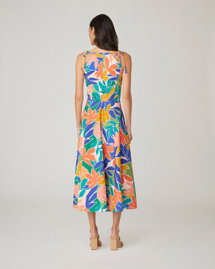 Floral printed cotton sleeveless midi sundress. This style features shoulder ties, a curved neckline, a fitted bodice with interior boning, and a full A-line midi skirt with side seam pockets. Bodice lined, skirt unlined. Hidden back zipper. 97% Cotton, 3% Spandex. Dry clean only. Color: Sunburst Multi Unlined A-line Midi Dress For Summer, Vacation A-line Midi Dress With Tie Back, Spring A-line Midi Dress With Tie Straps, Summer A-line Maxi Dress With Tie Waist, Summer A-line Unlined Midi Dress, Unlined Midi Dress For Summer, Summer A-line Sundress With Tie Back, Sleeveless Multicolor Tropical Print Midi Dress, Sleeveless Multicolor Midi Dress With Tropical Print