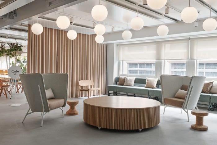 an office with couches, chairs and tables in it